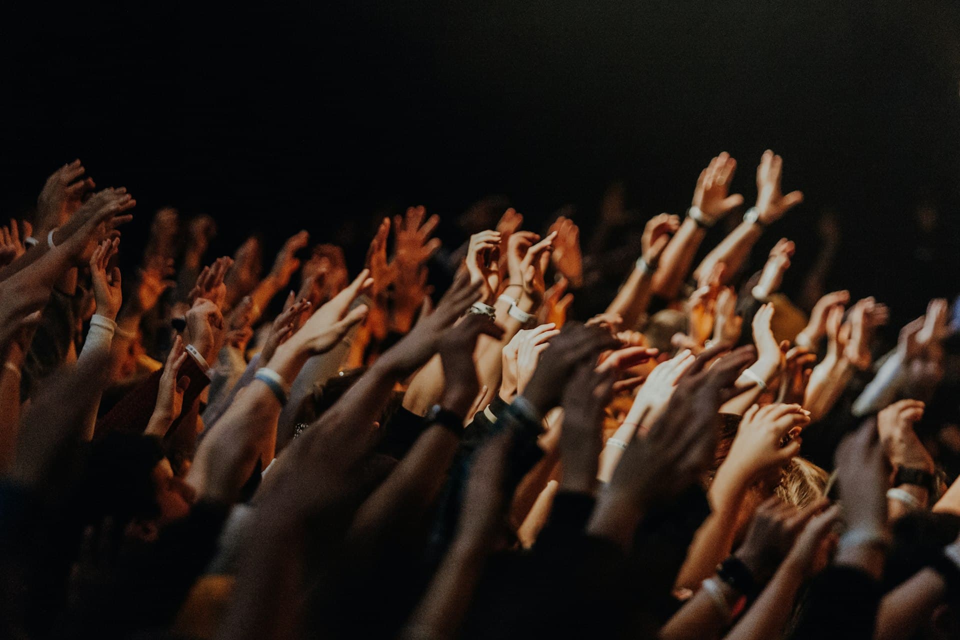 People raising their hands during a worship gathering